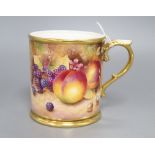 A Royal Worcester mug, designed with fruit and signed C.Hughes, height 12cm