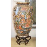 An early 20th century Japanese Satsuma ovoid pottery vase, 46cm, on hardwood stand