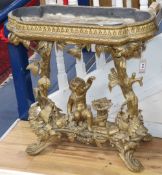 A Victorian carved giltwood and gesso jardinière table, child and trees underframe, W.83cm