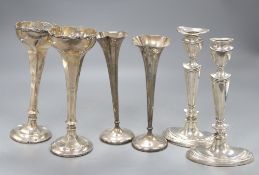 A pair of George V silver candlesticks, (lacking one sconce) 20cm, a pair of specimen vases, 19cm