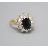 An 18ct gold sapphire and diamond oval cluster ring, size J