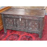 An early 18th century later carved oak coffer, W.127cm