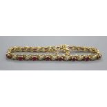 An 18ct gold diamond and ruby set bracelet, gross 21.5 grams