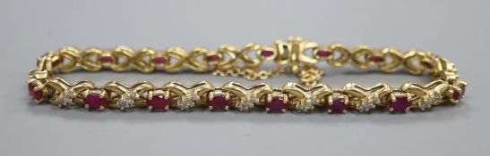 An 18ct gold diamond and ruby set bracelet, gross 21.5 grams