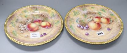 A pair of Aynsley cabinet plates, painted with plums and apples by Paul English, diameter 26cm