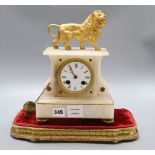 A 19th century French eight day alabaster mantel clock, surmounted by a gilt metal model of a