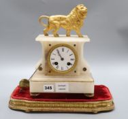A 19th century French eight day alabaster mantel clock, surmounted by a gilt metal model of a