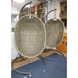 A pair of hanging rattan chairs