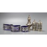 A George V four piece pierced silver condiment set, Birmingham 1916, a similar salt and an octagonal