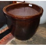 A cream glazed pottery garden planter, a similar brown glazed pot, largest 53cm diameter, H.47cm