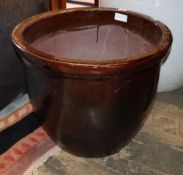 A cream glazed pottery garden planter, a similar brown glazed pot, largest 53cm diameter, H.47cm