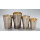 Three 19th century Indian white metal tumbler cups, retailer's Grish C.Dutt of Calcutta (2) and