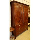 A Regency mahogany linen press, fitted oval panelled doors now enclosing hanging space to the left