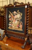 A Victorian rosewood framed fire screen with needlework panel, W.71cm