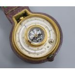 A late Victorian brass travelling barometer, thermometer and compass, cased