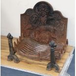 A cast iron fire grate, dogs and lion and thistle fireback, W.64cm, H.62cm