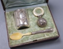A French white metal christening set comprising tumbler, rattle and ivory bowl and spoon, c.1900, in