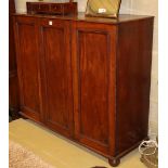 A Victorian panelled mahogany three door linen press, doors enclosing three sliding trays, W.