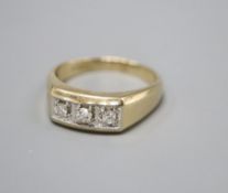 A 9ct. gold three stone diamond ring, larger than size Z, gross 7.3 grams