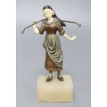 A 19th century cold painted bronze and ivory figure of a milkmaid, on an onyx base, overall height