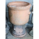 A terracotta garden urn on pedestal, W.50cm, H.73cm