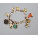 An 18ct gold curblink charm bracelet, hung with ten assorted charms, gross 58 grams