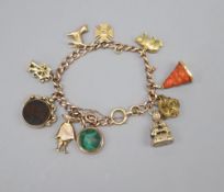 An 18ct gold curblink charm bracelet, hung with ten assorted charms, gross 58 grams