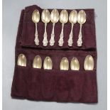 A set of twelve American sterling coffee spoons, the handles cast with scrolls, Venus and Cupid