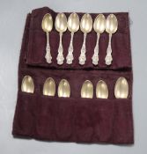 A set of twelve American sterling coffee spoons, the handles cast with scrolls, Venus and Cupid