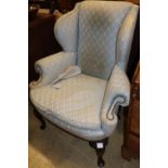 A Queen Anne design mahogany framed wing armchair, on all round cabriole legs