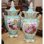 A pair of Ridgway turquoise and gilt ground two handled lidded vases, each painted with panels of