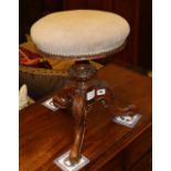 A Victorian circular topped revolving piano stool