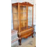 An Anglo Indian walnut two door china display cabinet, on short cabriole legs with claw and ball