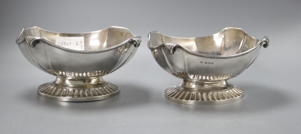 A pair of George V oval silver bowls with scrolling rims and heavy fluted bases, stamped Alexander