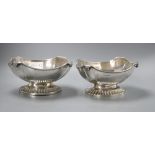 A pair of George V oval silver bowls with scrolling rims and heavy fluted bases, stamped Alexander