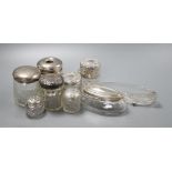 Eight assorted silver lidded glass toilet jars, a further glass jar lacking lid and a small pair