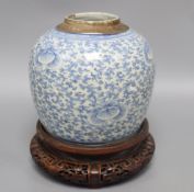 A 19th century Chinese blue and white jar and carved wood stand