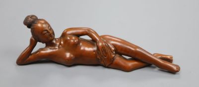 A Chinese wood figure of a reclining nude, width 20cm