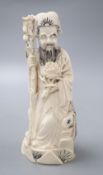 A Chinese ivory man holding flower