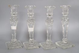 A set of four late Victorian glass candlesticks ,height 26cm