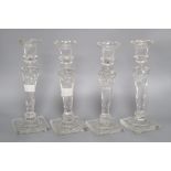 A set of four late Victorian glass candlesticks ,height 26cm