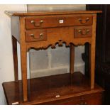 A George III oak lowboy, W.77cm