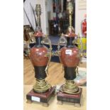 A pair of rouge marble and slate urn lamps
