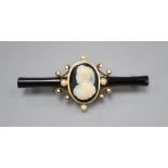 A Victorian gold, enamel and pearl bar brooch, set with a central cameo, 5.5cm
