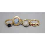 Three 18ct gold dress rings: diamond cluster, size K, ruby and diamond three stone, size O and