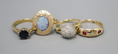 Three 18ct gold dress rings: diamond cluster, size K, ruby and diamond three stone, size O and