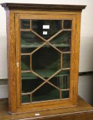 A George III oak hanging corner cabinet, W.68cm