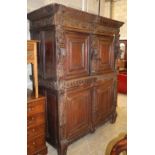 A 19th century Jacobean revival carved oak press cupboard, W.157cm, H.197cm