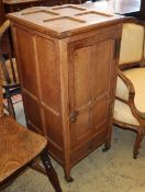 An Arts & Crafts panelled oak bedside cupboard, W.41cm