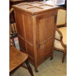 An Arts & Crafts panelled oak bedside cupboard, W.41cm